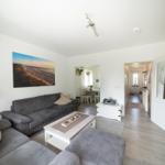 Wohnzimmer mit Sofa, Couchtisch und Blick in Essbereich.