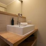 Sink on wooden vanity with mirror and towel