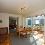 Dining room with table, chairs, and view of terrace.