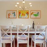 Dining room with table, chairs, and wall art.