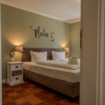 Bedroom with bed, nightstand, and wall decoration.