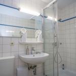 Bathroom with shower, sink, and mirror