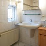 Bathroom with sink, mirror, and window