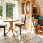Dining room with table, two chairs, and TV. Garden visible outside.