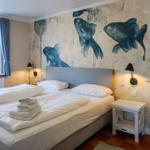 Bedroom with bed, fish wall mural, and nightstand.
