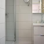 Bathroom with shower, sink, and mirror