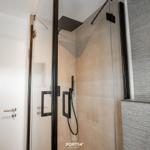 Shower with glass enclosure and showerhead