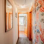 Flur mit Meerestier-Wandtapete und Spiegel an der Wand.