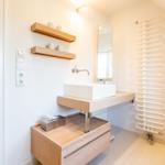 Bathroom with sink, mirror, and radiator