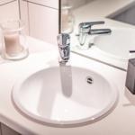 Sink with mirror, faucet, and soap