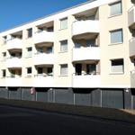 Modern apartment building with balconies and garages