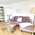 Living room with sofa, coffee table, and floor lamp.