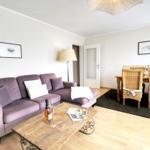 Living and dining area with sofa, table and chairs.