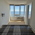 Room with sea view, wooden floor, and bed frame
