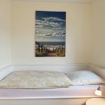 Bedroom with bed and wall picture on the wall