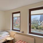 Bedroom with view of garden and house