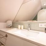 Bathroom with sink, mirror, and towel rack