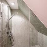 Shower with glass enclosure and handheld showerhead