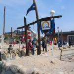 Outdoor playground with sand, stones, and slide for children.