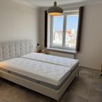 Bedroom with double bed, window, and nightstands.
