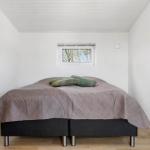 Bedroom with bed, window, and radiator.