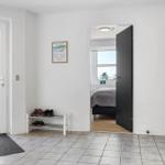 Entrance with shoe rack, door to bedroom, and window to outside.