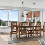 Dining room with wooden table, chairs, and view of fields