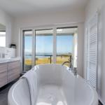 Bad mit Badewanne und Aussicht auf See