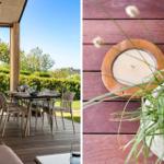 Terrace with table and chairs, view of green hedge and tree. Wooden tray and plant on deck floor.