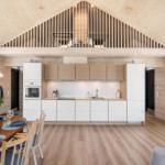 Kitchen with dining area and upper level, wooden ceiling and walls.