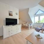 Living and dining area with TV, recliner, and window