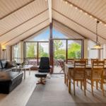 Living and dining area with seating and view of the garden.