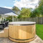 House with garden, hot tub, and seating area.