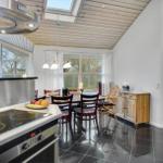 Kitchen with dining area and view into bedroom