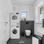 Bathroom with washing machine, dryer, toilet, and sink