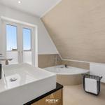 Bathroom with shower, sink, and window. Wall with ship motif.