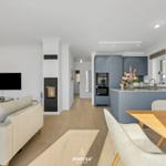 Living and dining area with kitchen island, TV, and fireplace.