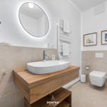 Bathroom with sink, mirror, toilet, and towel rack.