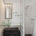 Bathroom with shower, mirror, and glass sink.