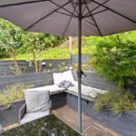 Terrace with bench, umbrella, and plants
