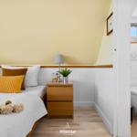 Bedroom with bed, nightstand, and attached bathroom.