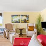 Living room with seating, TV, and view of the landscape.