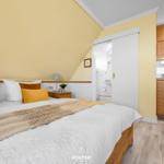 Bedroom with double bed, kitchen area, and bathroom.