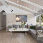 Living room with sofa, table, and large windows. Wooden walls and ceiling.