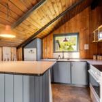 Kitchen with wooden walls, countertop, and window