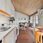 Kitchen with dining area and living room in the background.