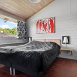 Bedroom with bed, window, and wall art.