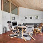 Living room with fireplace, seating area, and dining space on terracotta floor.