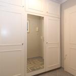 Back entrance with white doors and a mirrored panel.