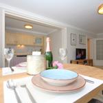 Dining table with dishes and a champagne bottle in the living area